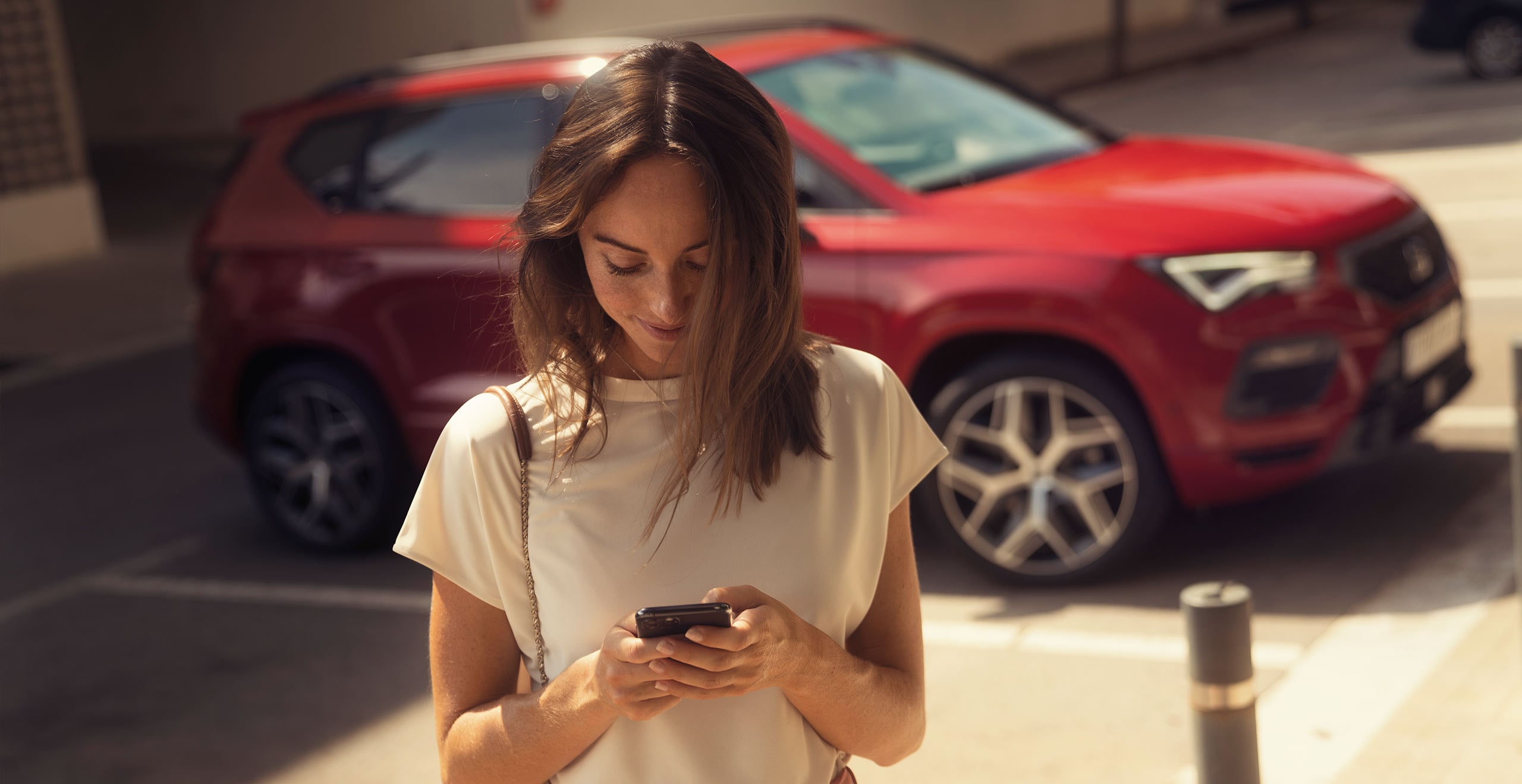 Woman using SEAT CONNECT with her new SEAT Ateca desire red